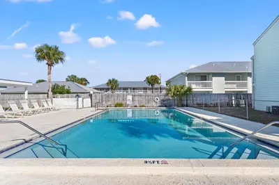 a swimming pool in front of a house at Southwind by Panhandle Getaways in Panama City Beach