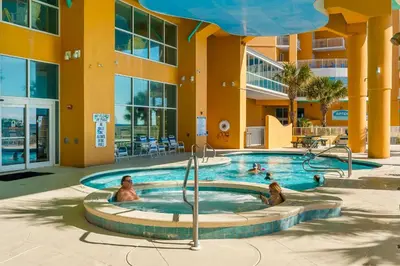 a pool at a resort with people in it at Splash Beach Resort by Panhandle Getaways in Panama City Beach