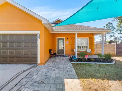 a orange house with a garage and a do not enter sign at Orange Crush in Panama City Beach