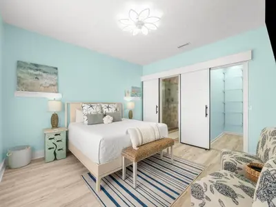 a bedroom with a bed and a living room at Orange Crush in Panama City Beach