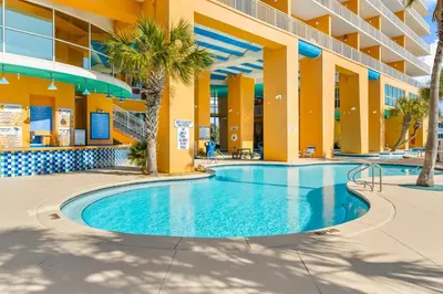 a swimming pool in the middle of a building at Splash Beach Resort by Panhandle Getaways in Panama City Beach