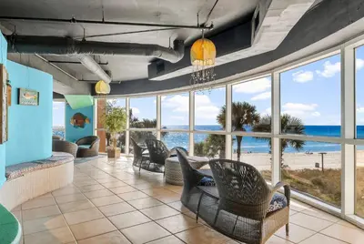 a living room with a view of the ocean at Splash Beach Resort by Panhandle Getaways in Panama City Beach