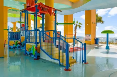a playground in a water park with a slide at Splash Beach Resort by Panhandle Getaways in Panama City Beach