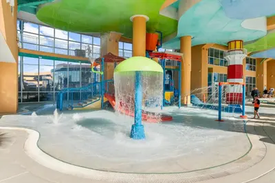 a water park with a water slide in a building at Splash Beach Resort by Panhandle Getaways in Panama City Beach