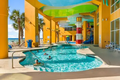a pool at a resort with people in it at Splash Beach Resort by Panhandle Getaways in Panama City Beach
