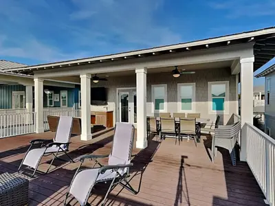 a deck with chairs and a table on a house at Sunny Side Up in Inlet Beach