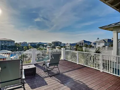 a balcony with a chair on a deck at Sunny Side Up in Inlet Beach