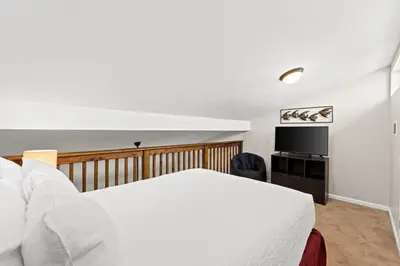 a bedroom with a bed and a flat screen tv at Sunswept by Panhandle Getaways in Panama City Beach