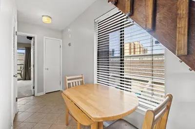 a dining room with a table and a large window at Sunswept by Panhandle Getaways in Panama City Beach