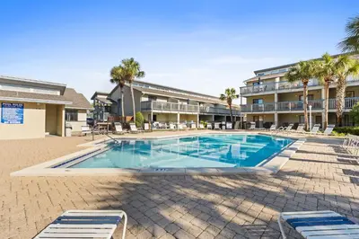 a swimming pool in front of a building at Sunswept by Panhandle Getaways in Panama City Beach
