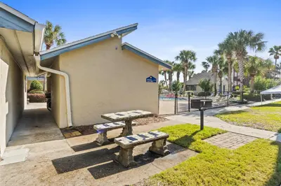 a couple of benches sitting outside of a building at Sunswept by Panhandle Getaways in Panama City Beach