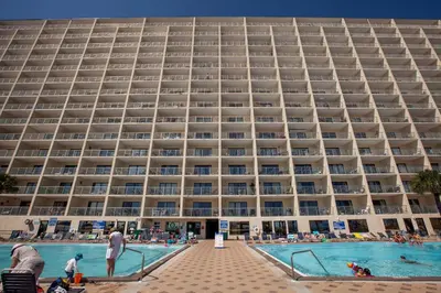 a large building with a pool in front of it at The Summit by Panhandle Getaways in Panama City Beach