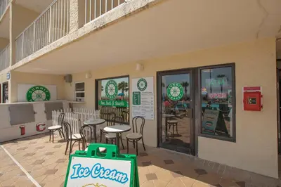 a ice cream shop with tables and chairs in a building at The Summit by Panhandle Getaways in Panama City Beach