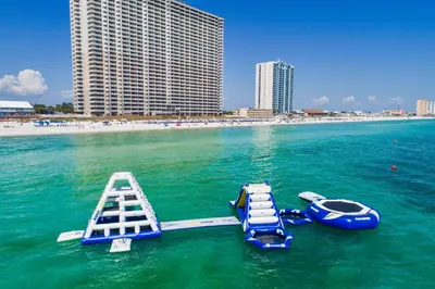 two boats in the water next to a beach at Tidewater Beach Resort by Panhandle Getaways in Panama City Beach