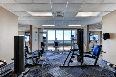 a gym with chairs and a view of the ocean at Tidewater Beach Resort by Panhandle Getaways in Panama City Beach