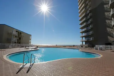 a swimming pool in front of a building at Tidewater Beach Resort by Panhandle Getaways in Panama City Beach