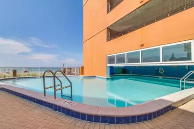 a large swimming pool next to a building at Tropic Winds Resort by Panhandle Getaways in Panama City Beach