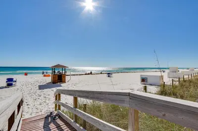 a view of the beach from the balcony of a beach house at Tropic Winds Resort by Panhandle Getaways in Panama City Beach