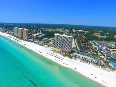 an aerial view of a beach with buildings and the ocean at Tropic Winds Resort by Panhandle Getaways in Panama City Beach