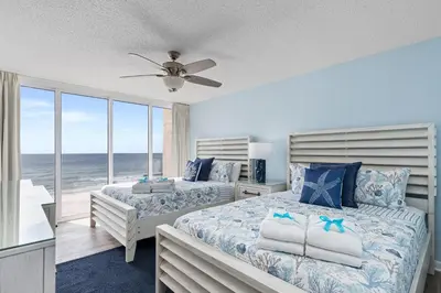 two beds in a bedroom with a view of the ocean at Come Enjoy KC & The Sunshine State: 3-Bed, 3-Bath With Stunning Ocean Views in Panama City Beach