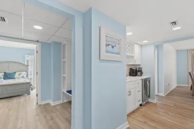 a living room with a bed and a kitchen at Come Enjoy KC & The Sunshine State: 3-Bed, 3-Bath With Stunning Ocean Views in Panama City Beach