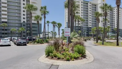 a street with a parking lot with palm trees at Come Enjoy KC & The Sunshine State: 3-Bed, 3-Bath With Stunning Ocean Views in Panama City Beach