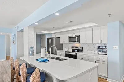 a kitchen with white cabinets and a white counter top at Come Enjoy KC & The Sunshine State: 3-Bed, 3-Bath With Stunning Ocean Views in Panama City Beach