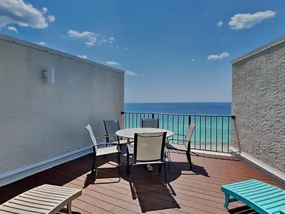 a patio with a table and chairs on a balcony at Edgewater Tower III #1205 in Panama City Beach