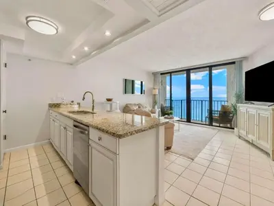 a kitchen with a sink and a view of the ocean at Edgewater Tower III #1205 in Panama City Beach