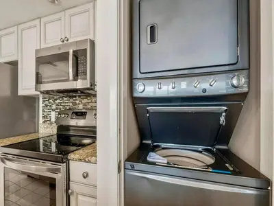 a kitchen with a stainless steel stove and microwave at Edgewater Tower III #1205 in Panama City Beach