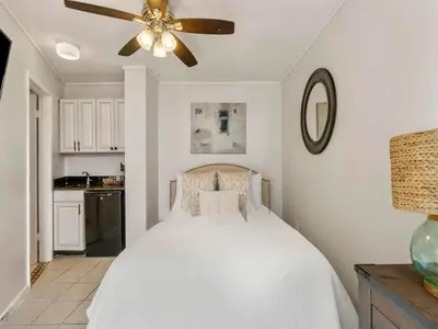 a bedroom with a bed with a ceiling fan at Edgewater Tower III #1205 in Panama City Beach
