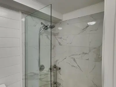 a bathroom with a shower with a glass door at Edgewater Tower III #1205 in Panama City Beach