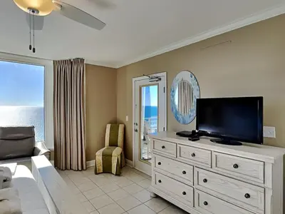 a living room with a television on a dresser at Emerald Beach #2531 in Panama City Beach