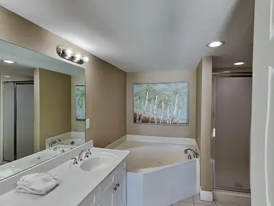a bathroom with a tub and a sink and a bath tub at Emerald Beach #2531 in Panama City Beach