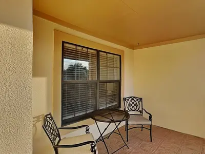 a room with a table and chairs and a window at Horizon South #76G in Panama City Beach