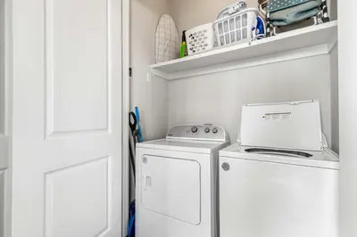 a laundry room with a washer and dryer at Modern Coastal Escape with Fire Pit & Pool Access in Inlet Beach
