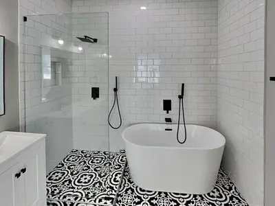 a white bathroom with a tub and a black and white floor at Sunset On Seabreeze in Inlet Beach