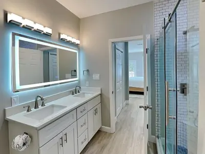 a bathroom with two sinks and a mirror at Sunset On Seabreeze in Inlet Beach