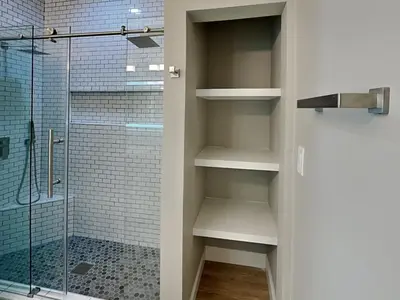 a bathroom with a walk in shower next to a glass door at Sunset On Seabreeze in Inlet Beach
