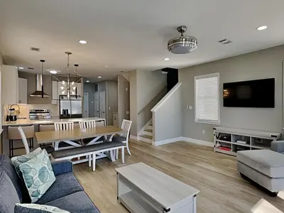 a living room with a table and a dining room at Sunset On Seabreeze in Inlet Beach