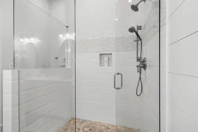 a bathroom with a shower with a glass door at The Village Happy Life Condo - Private Beach Access Pool & Hot Tub in Rosemary Beach