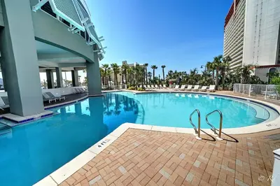 a swimming pool with a pair of sandals in it at Laketown Wharf 2115 Penthouse with Gulf Views in PCB - Sleeps 6 in Panama City Beach