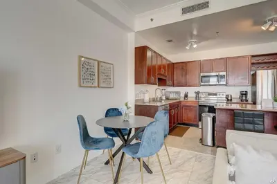a kitchen with a table and some blue chairs at Laketown Wharf 2115 Penthouse with Gulf Views in PCB - Sleeps 6 in Panama City Beach