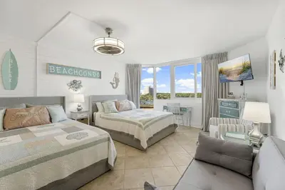 a bedroom with two beds and a couch at Beach Front Ocean View Condo - Top of the Gulf 804 in Panama City Beach