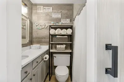 a bathroom with a toilet and a sink at Beach Front Ocean View Condo - Top of the Gulf 804 in Panama City Beach