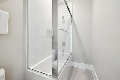a shower with a glass door in a bathroom at Four Blue Palms by 30A Escapes in Seacrest