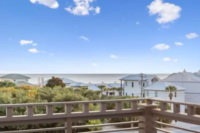 a view of the beach from the balcony of a house at Four Blue Palms by 30A Escapes in Seacrest