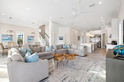a living room with a couch and a table at Four Blue Palms by 30A Escapes in Seacrest