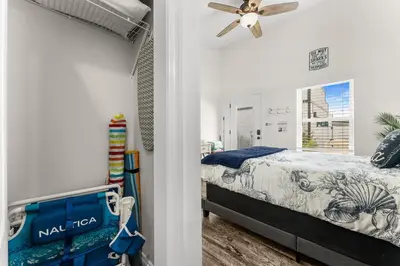 a bedroom with a bed and a ceiling fan at Tiny Treasure by Nautical Properties Vacation Rentals in Panama City Beach