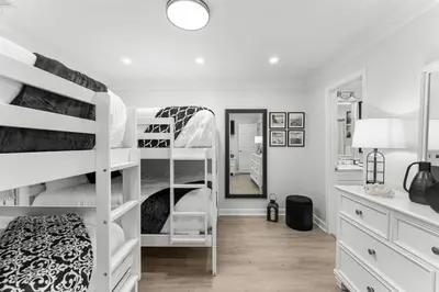 a bedroom with two bunk beds and a mirror at Gulf Highlands #177 by Nautical Properties in Panama City Beach